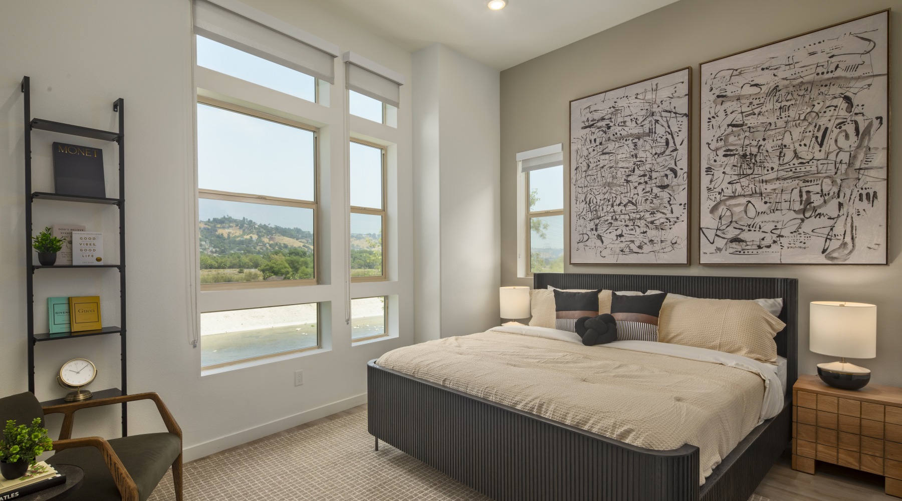 bedroom with big window and paintings above bed bedroom with big window and paintings above bed
