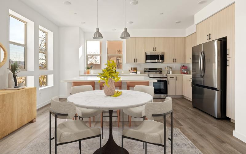 a kitchen with a dining table and chairs